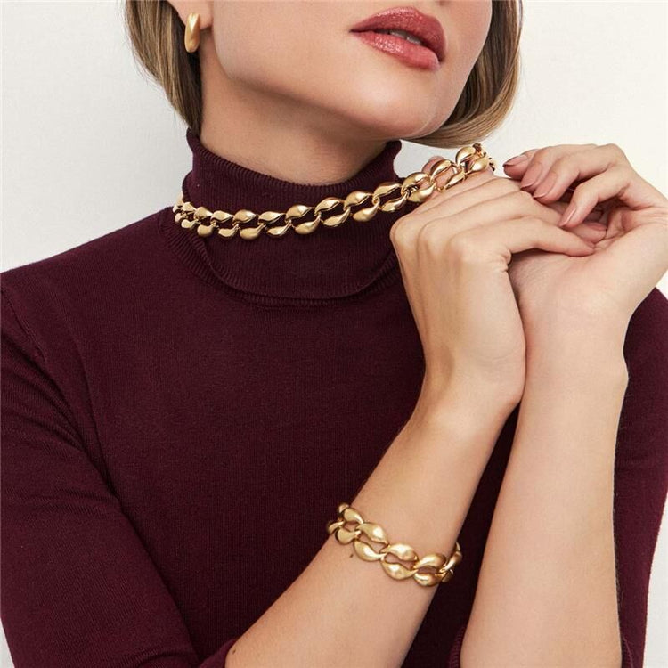 Modelo usando semijoias de alta qualidade em 18k e 24k antialérgicas, destacando brincos, anéis e colar elegantes.
